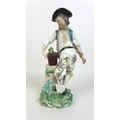 A Chelsea-Derby figure, circa 1770, modelled as a Gardener, wearing a black hat, white shirt, belt a... 