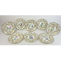 A set of eight 19th century porcelain botanical cabinet plates, possibly Coalport, with moulded shap... 