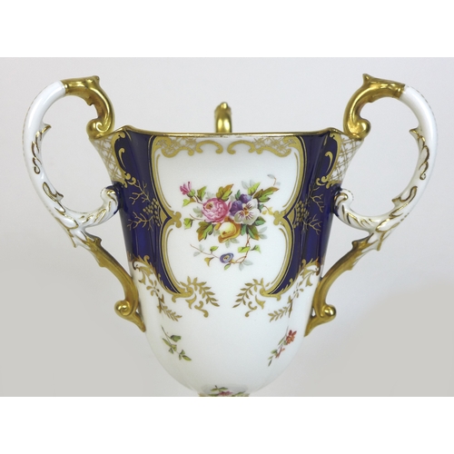 30 - An Edwardian Coalport porcelain goblet-vase, shape 144, modelled with three handles, flared rim, on ... 