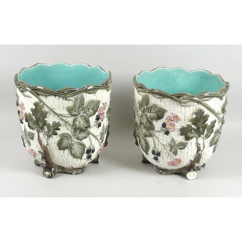 51 - A pair of Minton majolica jardinieres, late 19th century, decorated with a continuous moulded relief... 