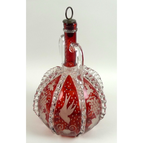 8 - A 19th century cranberry glass decanter, with twin handles, applied clear glass and wheel engraved d... 