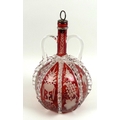 A 19th century cranberry glass decanter, with twin handles, applied clear glass and wheel engraved d... 
