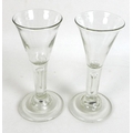 A pair of Georgian wine glasses, with trumpet shaped bowls, think stems with single bubble, wide foo... 