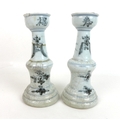 A pair of Chinese Ming style candlesticks, with stepped bases and two tiered columns, each decorated... 