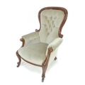A Victorian mahogany armchair, with buttoned grey upholstery and carved scroll decoration to wings a... 