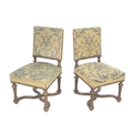 A pair of early 20th century oak side chairs, with carved frames, tapestry upholstered seats and bac... 