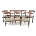 A set of Regency mahogany bar back dining chairs, tapestry drop in seats, with carved mid-rail, turn... 