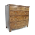 A Regency mahogany chest of two over three drawers, flat fronted, brass ring handles, raised on brac... 
