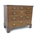 A George III oak chest of four graduating drawers, brass plate handles and escutcheons, raised on br... 
