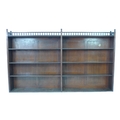 A wide Victorian oak bookcase, circa 1890, two divisions each with three adjustable shelves, open ga... 