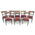 A set of eight early 19th century dining chairs, with bar backs and carved mid rail, drop in red vel... 