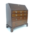 A George III mahogany bureau, fall front with fitted interior over three drawers with brass handles,... 