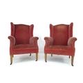 A pair of Edwardian wing armchairs, upholstered in pink velvet, raised on square section front legs ... 