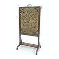 A 19th century mahogany fire screen, a lift out panel with gilt handle and embroidered with fourteen... 