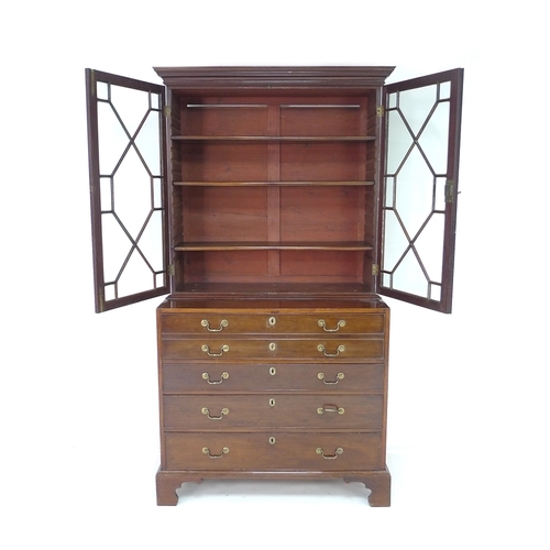 385 - A George III mahogany secretaire bookcase, the upper section with outswept cornice over two astragal... 