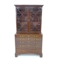A George III mahogany secretaire bookcase, the upper section with outswept cornice over two astragal... 