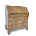 A Victorian bureau in George III style, walnut veneered, crossbanded and inlaid, fall front with fit... 