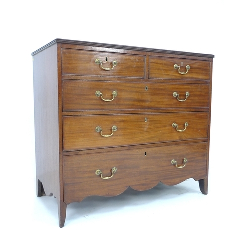 377 - A late George III mahogany chest of drawers, the two short over three long graduating drawers with b... 