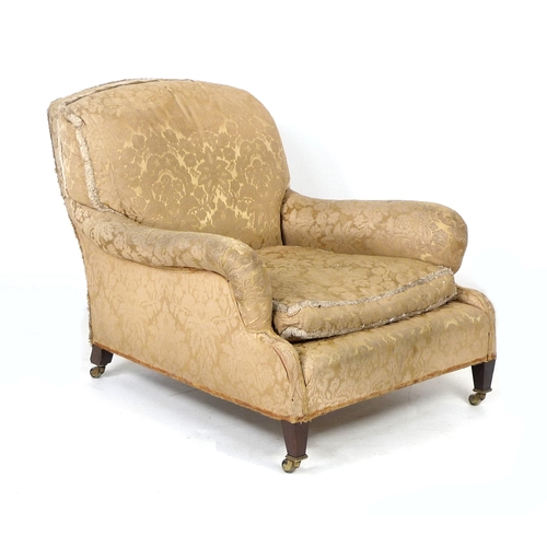 386 - An Edwardian mahogany easy armchair, probably Howard & Sons, Grafton model, with shaped back and ser...
