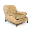 An Edwardian mahogany easy armchair, probably Howard & Sons, Grafton model, with shaped back and ser... 