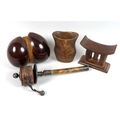 A group of four tribal and eastern wooden collectables, comprising an African or oceanic carved wood... 