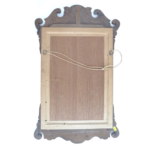 332 - A Georgian style mahogany fretwork wall mirror, with carved and gilded shell form crest and shaped o... 