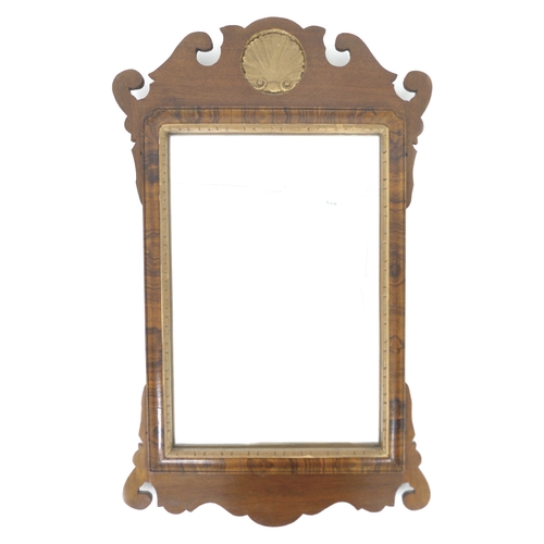 332 - A Georgian style mahogany fretwork wall mirror, with carved and gilded shell form crest and shaped o... 