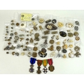A large collection of military cap badges, buttons and medals, including some WWI and WWII pieces, f... 