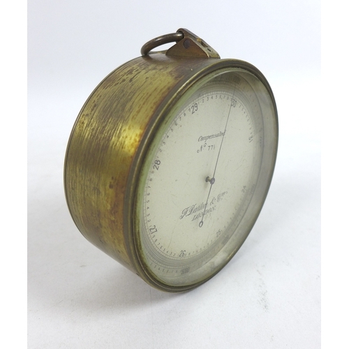 142 - A WWI brass aneroid barometer, by F. Darton & Co, London, of circular form with silvered dial and br... 