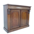 A Victorian mahogany chiffonier, single frieze drawer flanked by carved corbels, over twin cupboard ... 