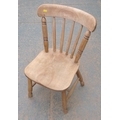 A child's oak Windsor side chair, mid 20th century, spindle back, bowed rail, shaped solid seat, tur... 
