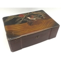 A Japanese lacquered box, early 20th century, the lid decorated with a bird of prey beneath a pine t... 