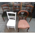 A group of five dining chairs, comprising a pair of Regency dining chairs with green velvet seats, a... 