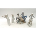 A group of four Lladro figurines, comprising Black Legacy Childrens games 5379 figural group, a boy ... 
