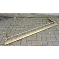 A Victorian brass fireside fender, with turned decorative spindles, 139 by 36 by 16cm high.