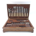 A 1930s oak cased canteen of silver plated flatware, canteen with blank cartouche.