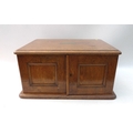 An early 20th century walnut canteen with three drawers, brass fittings and side handles, part fille... 