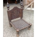 Afgan chair with carved back and woven seat.