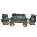 A Stress Less five piece suite, comprising a three seater settee, two chairs and two footstools, in ... 