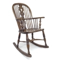 A 19th century ash and elm Windsor rocking chair, with shaped splats, turned supports, and crinoline... 
