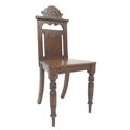 A late Victorian oak hall chair, with turned front legs and outswept back legs, 42.5 by 43 by 87cm h... 