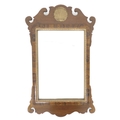 A Georgian style mahogany fretwork wall mirror, with carved and gilded shell form crest and shaped o... 