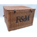 A Fortnum & Mason wicker hamper, black stencilled 'F&B' to front, leather closing straps and two car... 