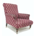 A Victorian style armchair, upholstered in burgundy fabric with gold foliate repeating pattern, with... 