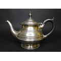 A George V Irish silver tea pot, of compressed baluster form, with plain banding, the hinged cover w... 
