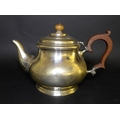 A George V silver teapot, of squat circular form, with ebonised handle and walnut finial, Adie Bros,... 