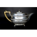 A Georgian silver teapot, with horn handle,  ebony finial, with armorial engraving, gadrooning to it... 