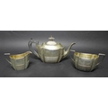 A Victorian silver three piece tea set, with bright cut decoration and reeded bases, comprising teap... 