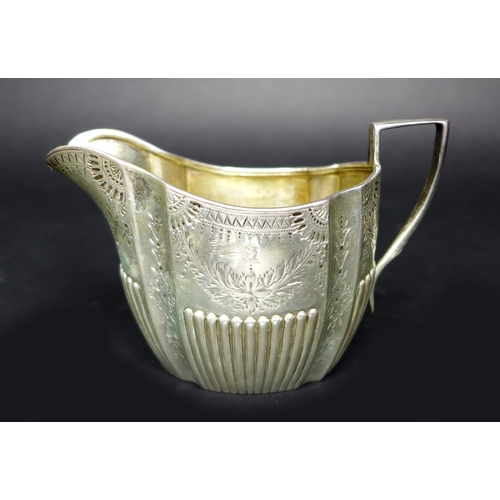 35 - A Victorian silver three piece tea set, with bright cut decoration and reeded bases, comprising teap... 