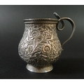 An Indian white metal cup, of baluster form, intricately decorated with flowers and foliage, with a ... 